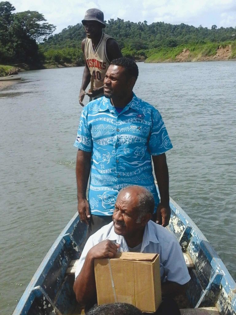 Two men canoe down a river