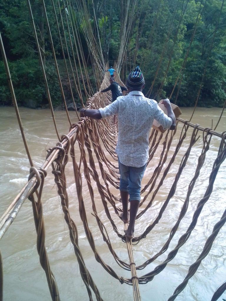 A man crosses a rope river