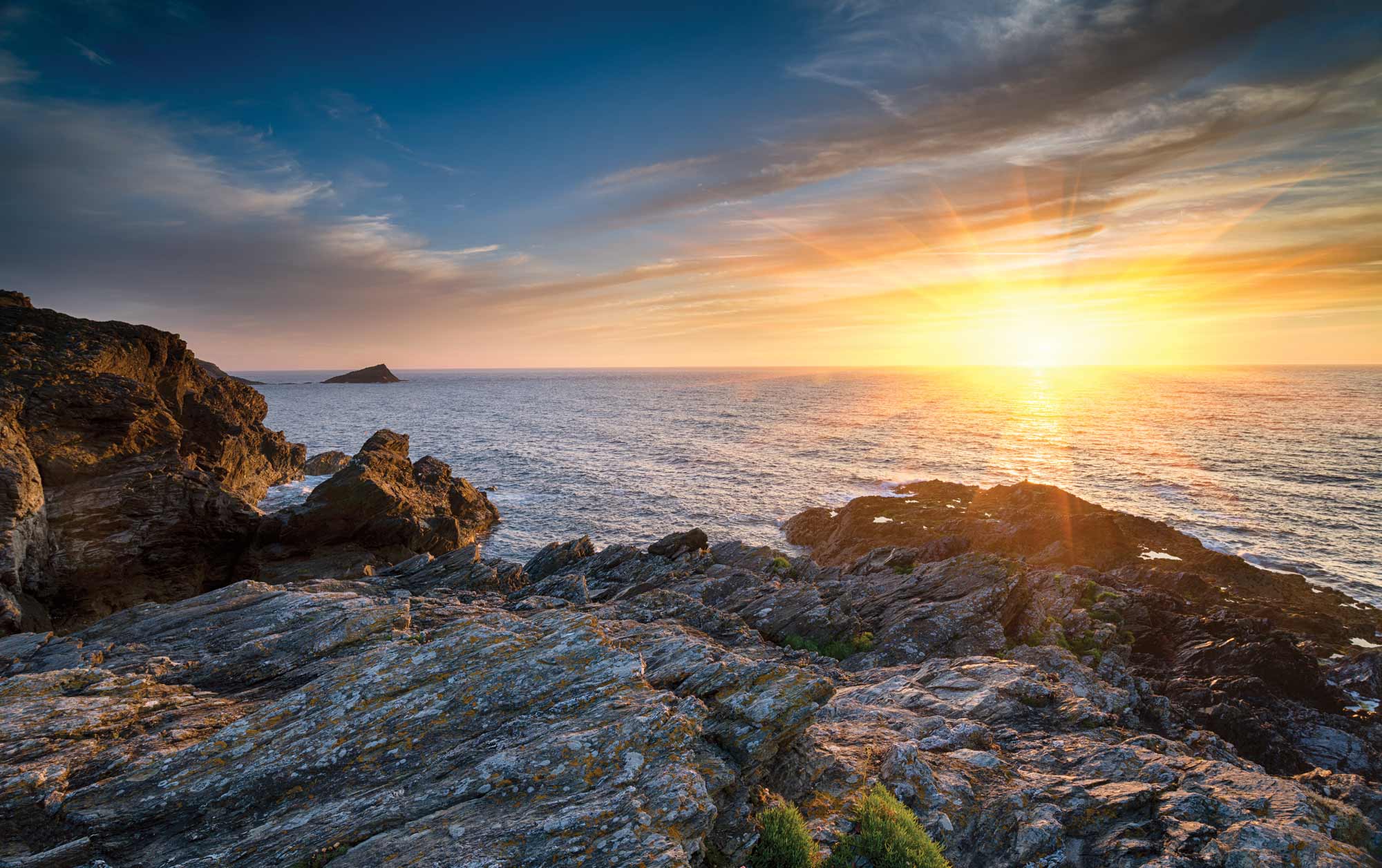The sun rises over ocean shores