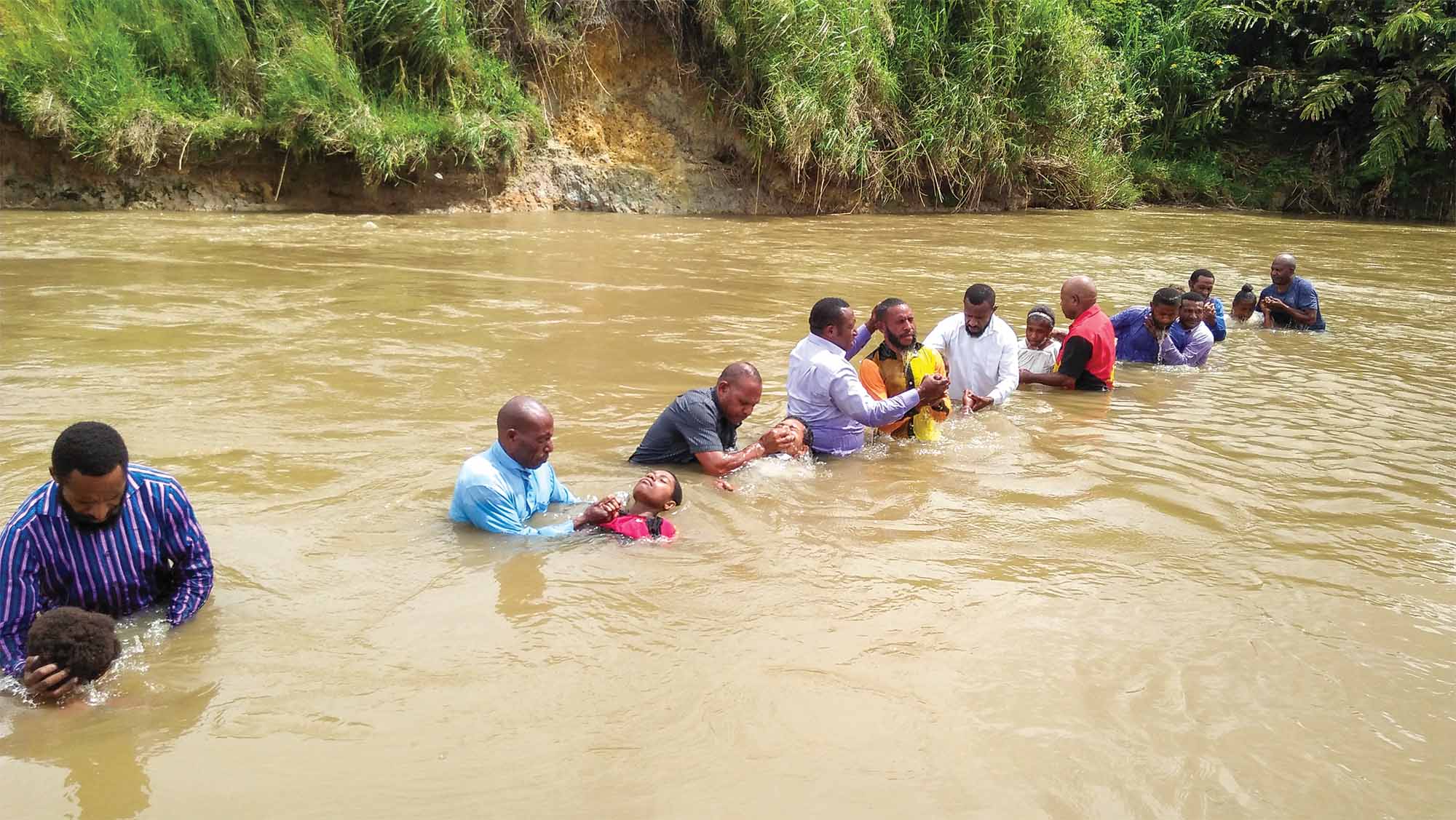 A group of Christians are baptized in a river in Papa New Guinea.